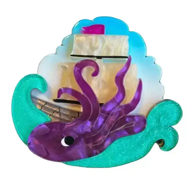 Decorative item with a ship and purple octopus on a black background